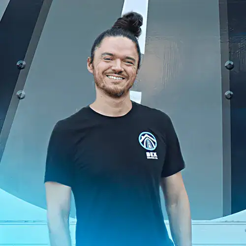 Erick+Perez+BEK-Crew Smiling man in black shirt with logo.