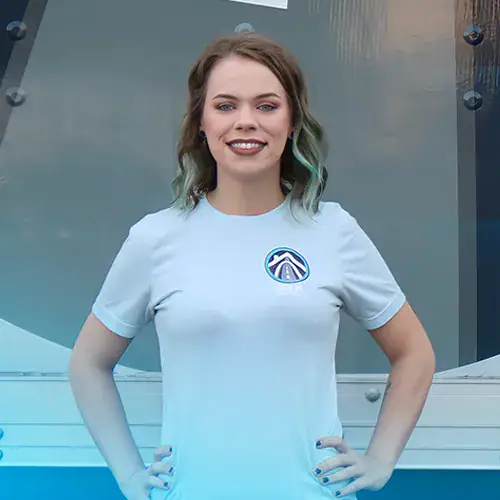 Selina+Beyer+BEK-Crew Woman smiling in blue graphic t-shirt outdoors.