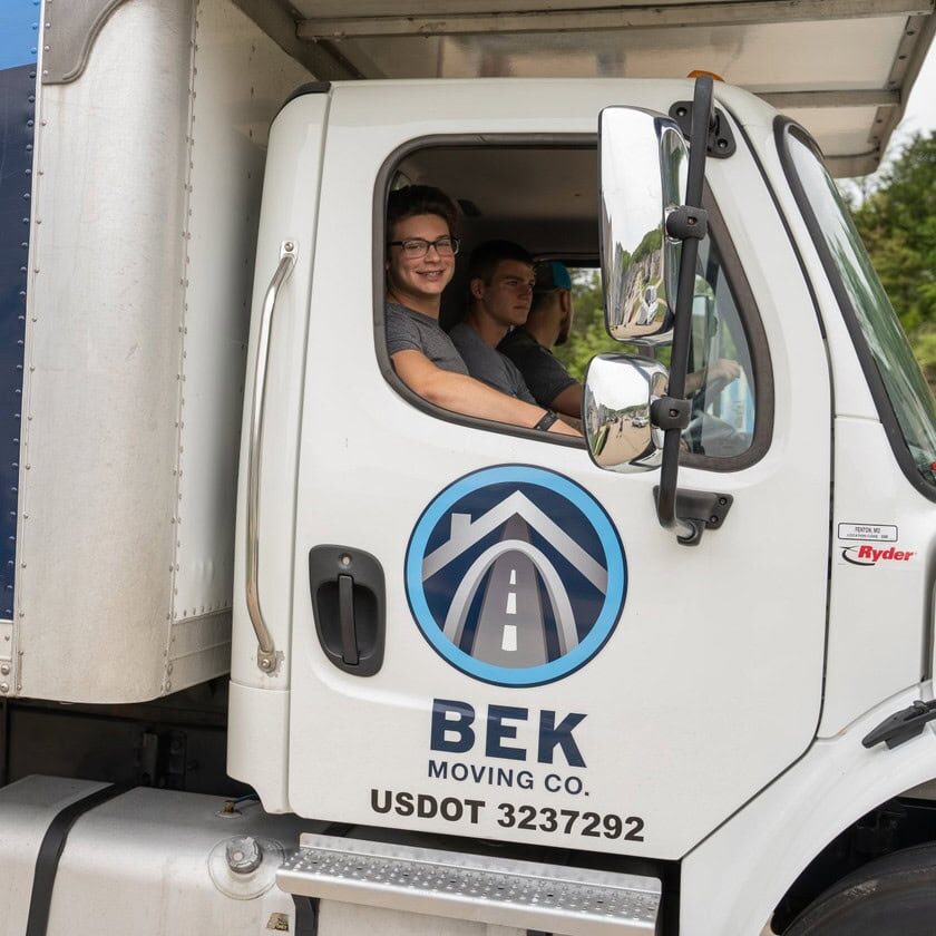BEK-moving-co-crew-in-truck-cabin Three Men Driving a BEK Moving Truck