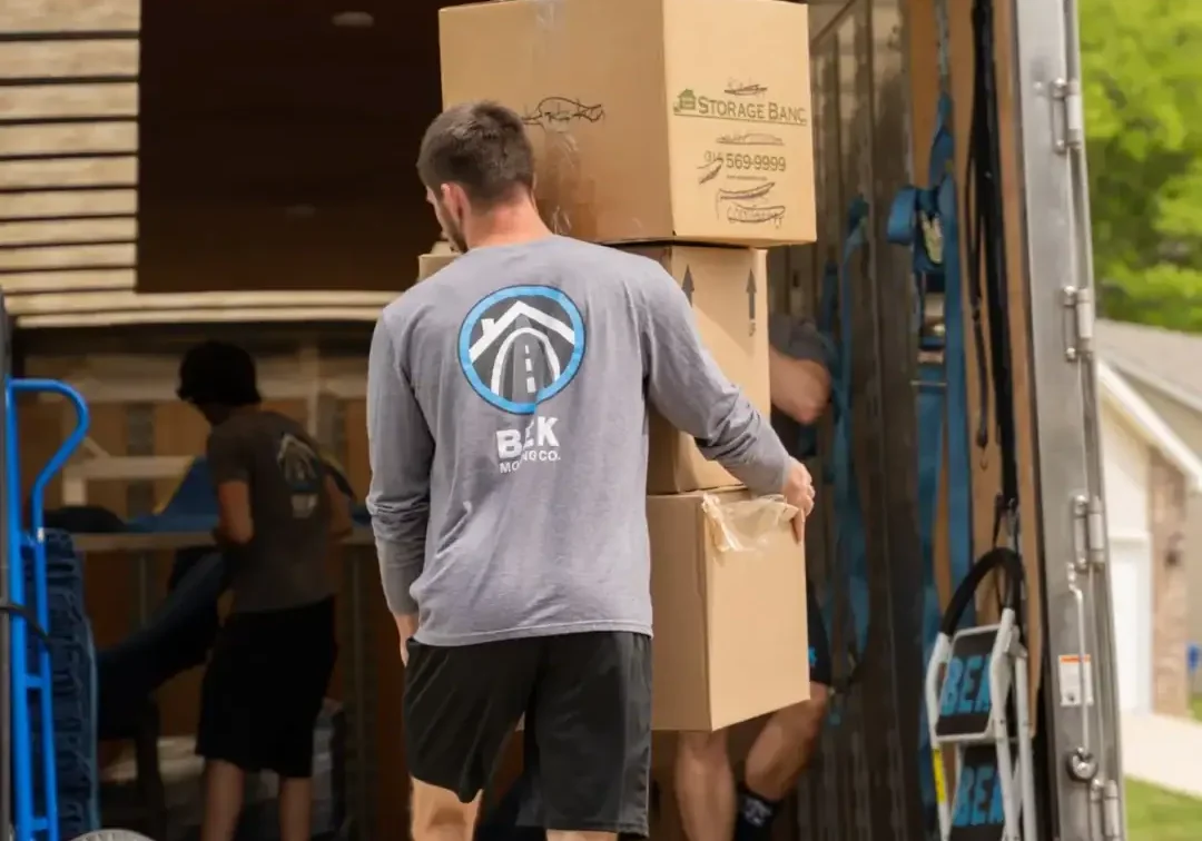 Moving-Image Movers loading boxes into a truck.