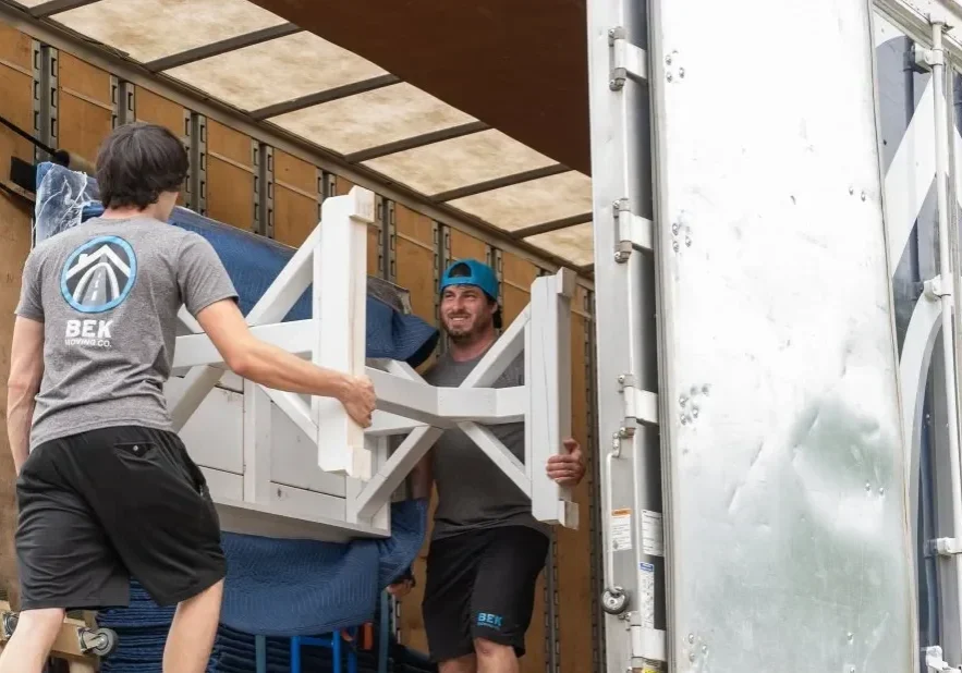 Movers loading furniture into a moving truck.