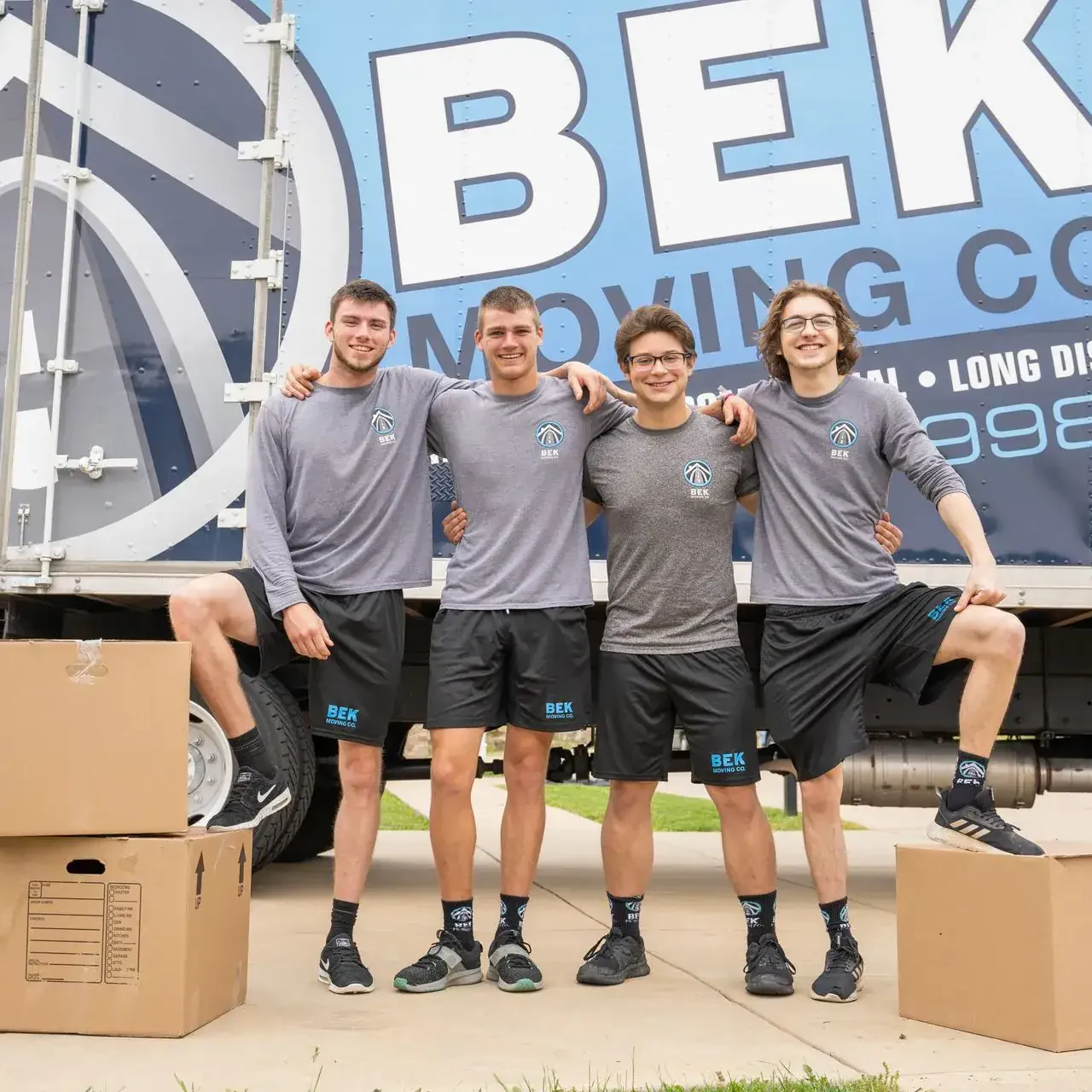 BEK Moving Company team with truck and boxes.