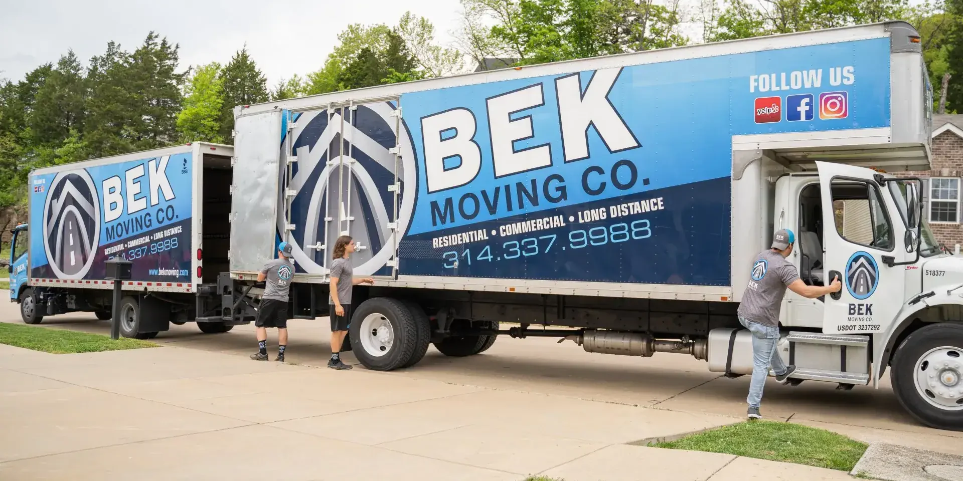 BEK Moving Co. trucks and workers outside.