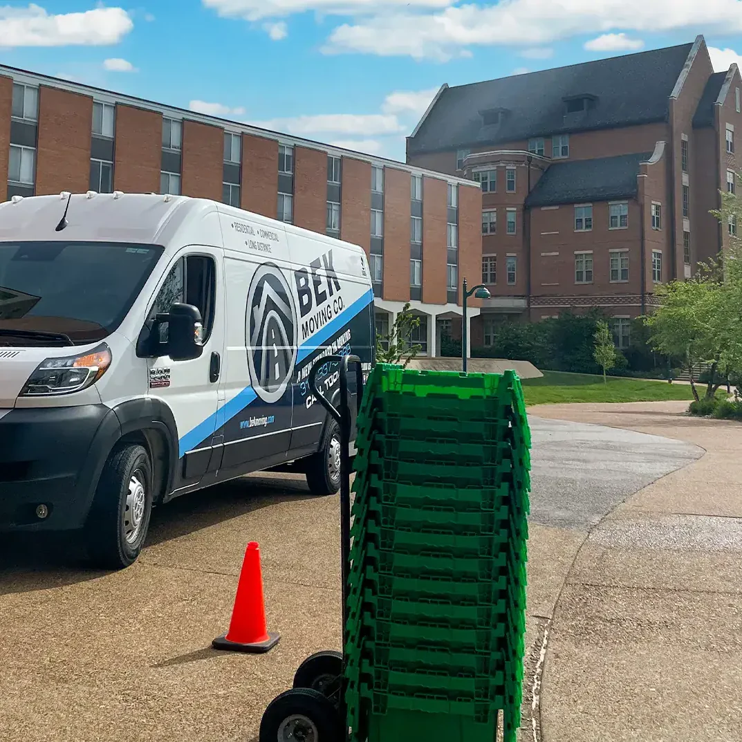 stack of green moving boxes bek moving van campus background