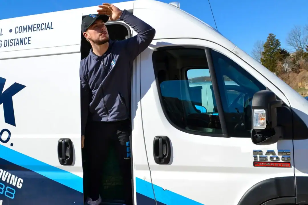Person looking out from a moving company van.