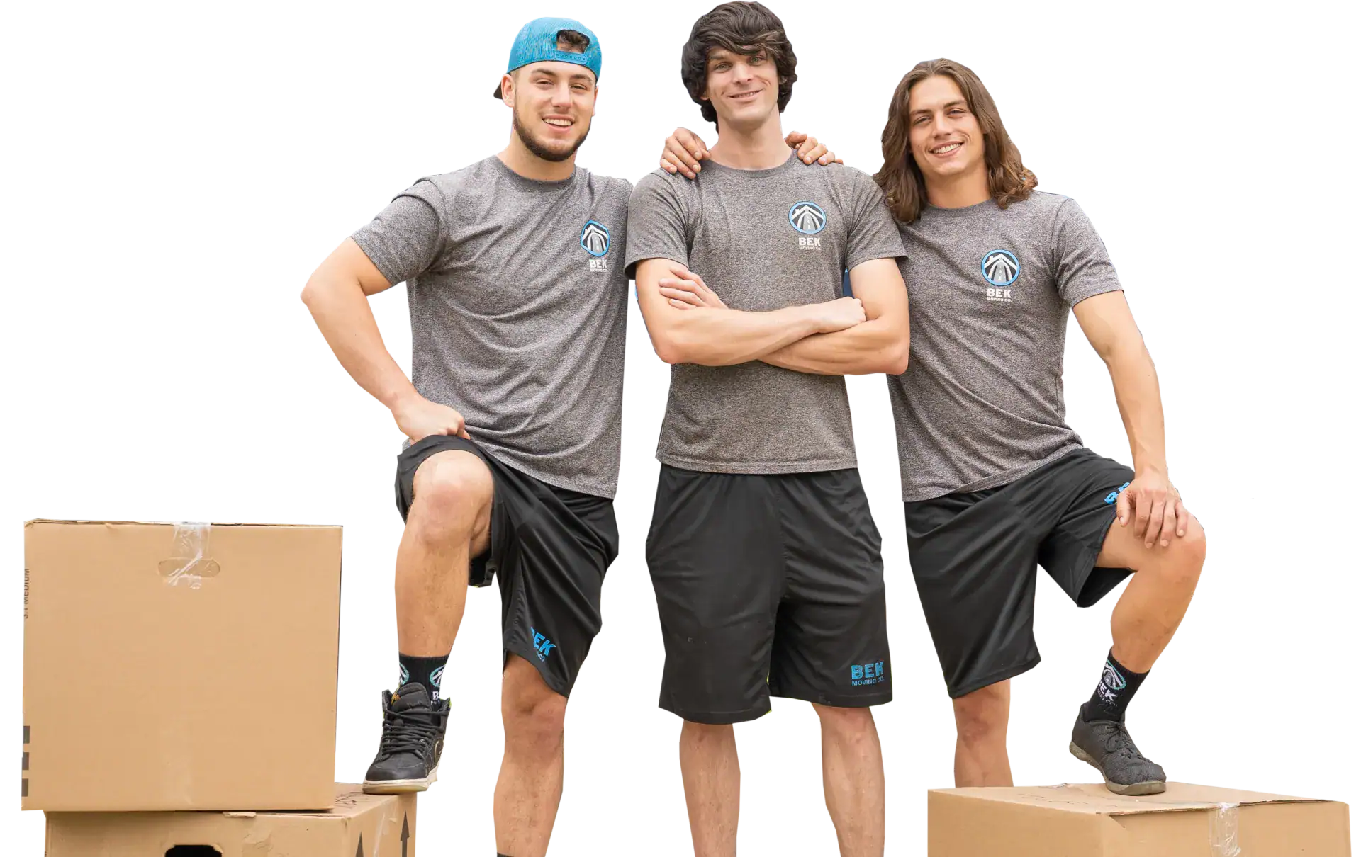 Three movers posing with cardboard boxes.